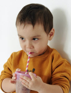 Young child drinking a sugary drink